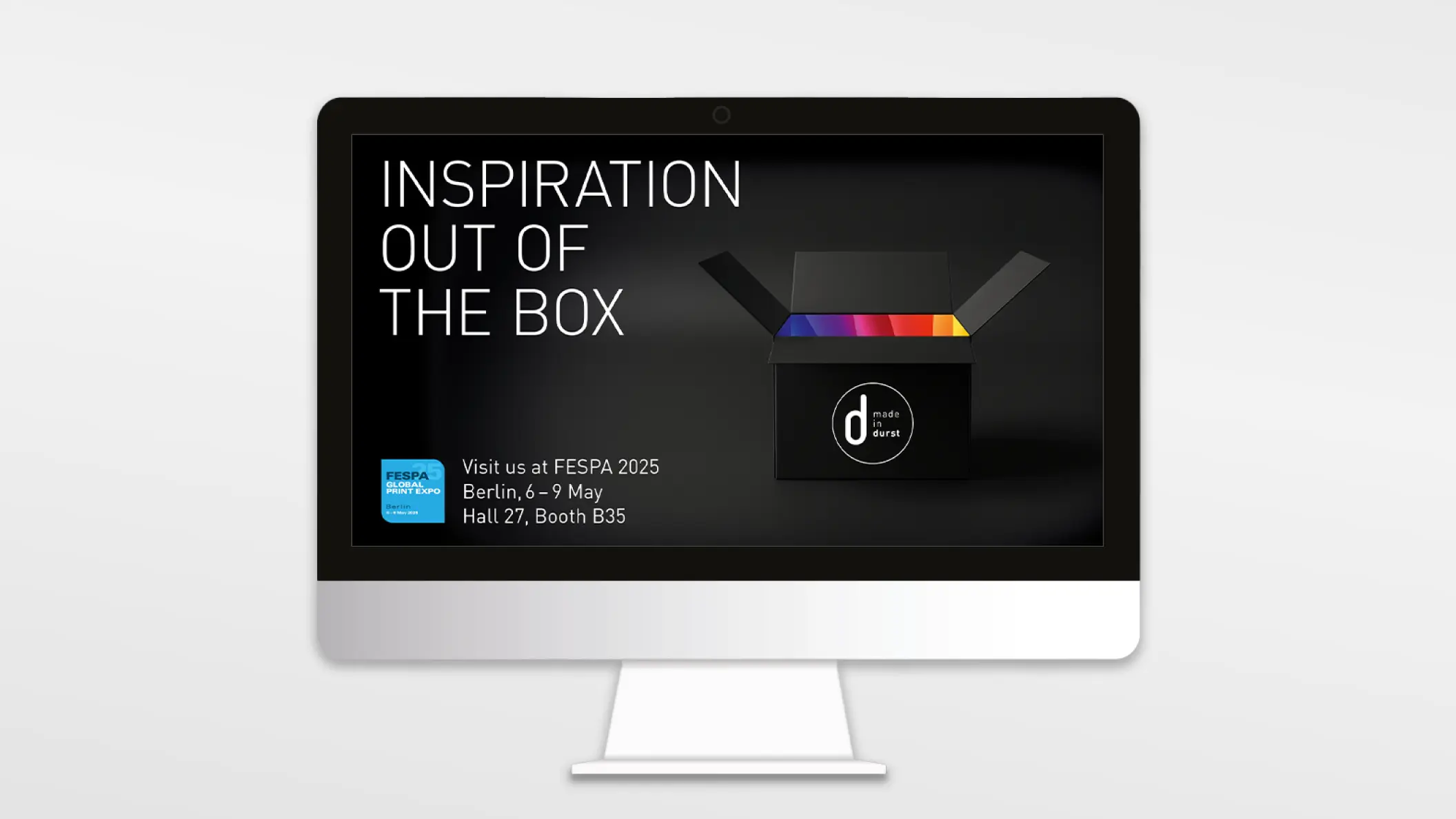 Durst, silberner Computer und darauf ein Key Visual mit einer schwarzen Box, in der bunte Farben leuchten und dem Slogan „Inspiration out of the box“, für die Messe FESPA 2025